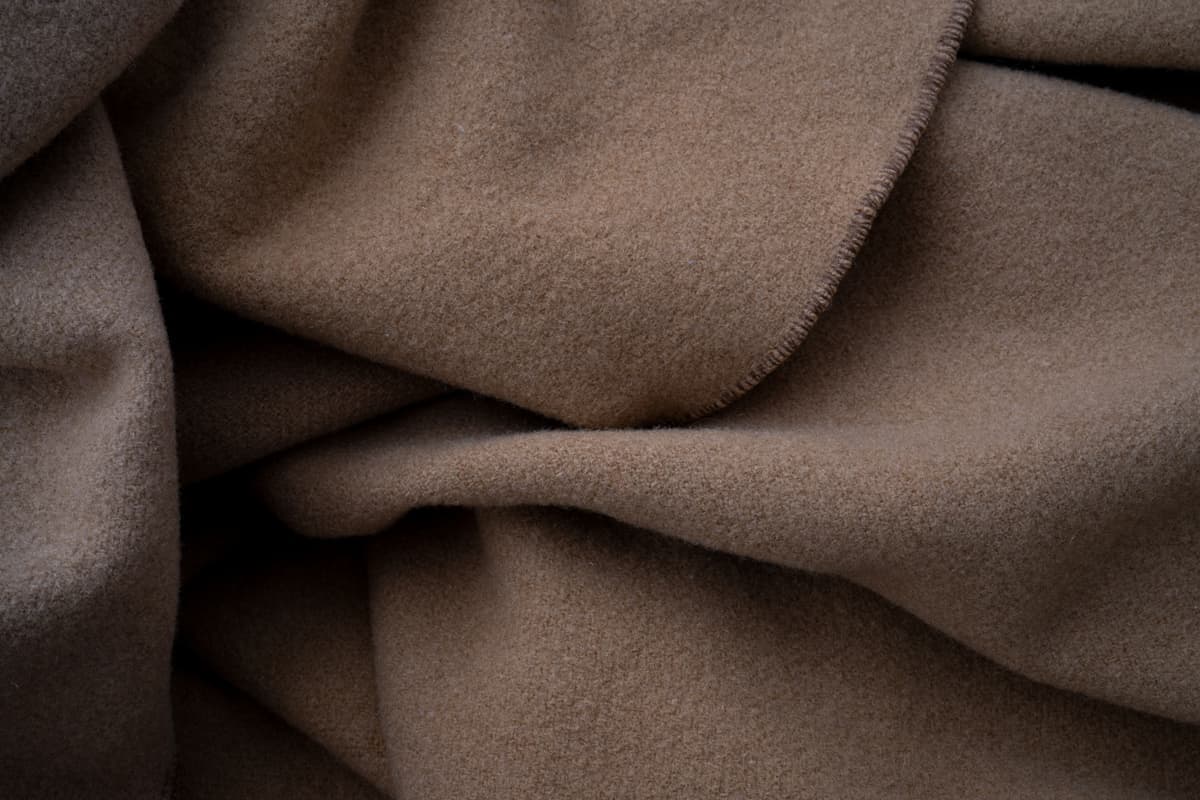 A worn folded blanket showing its texture