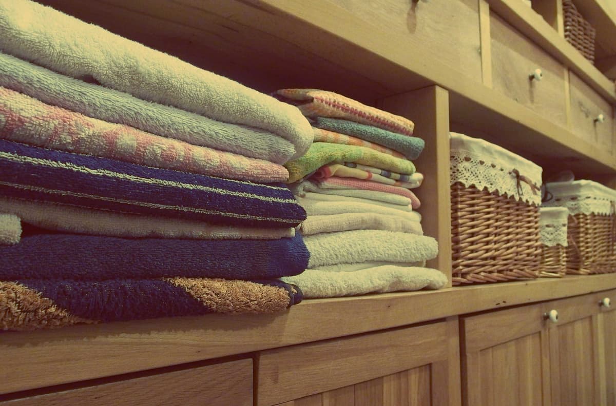 Folded linens on a closet shelf