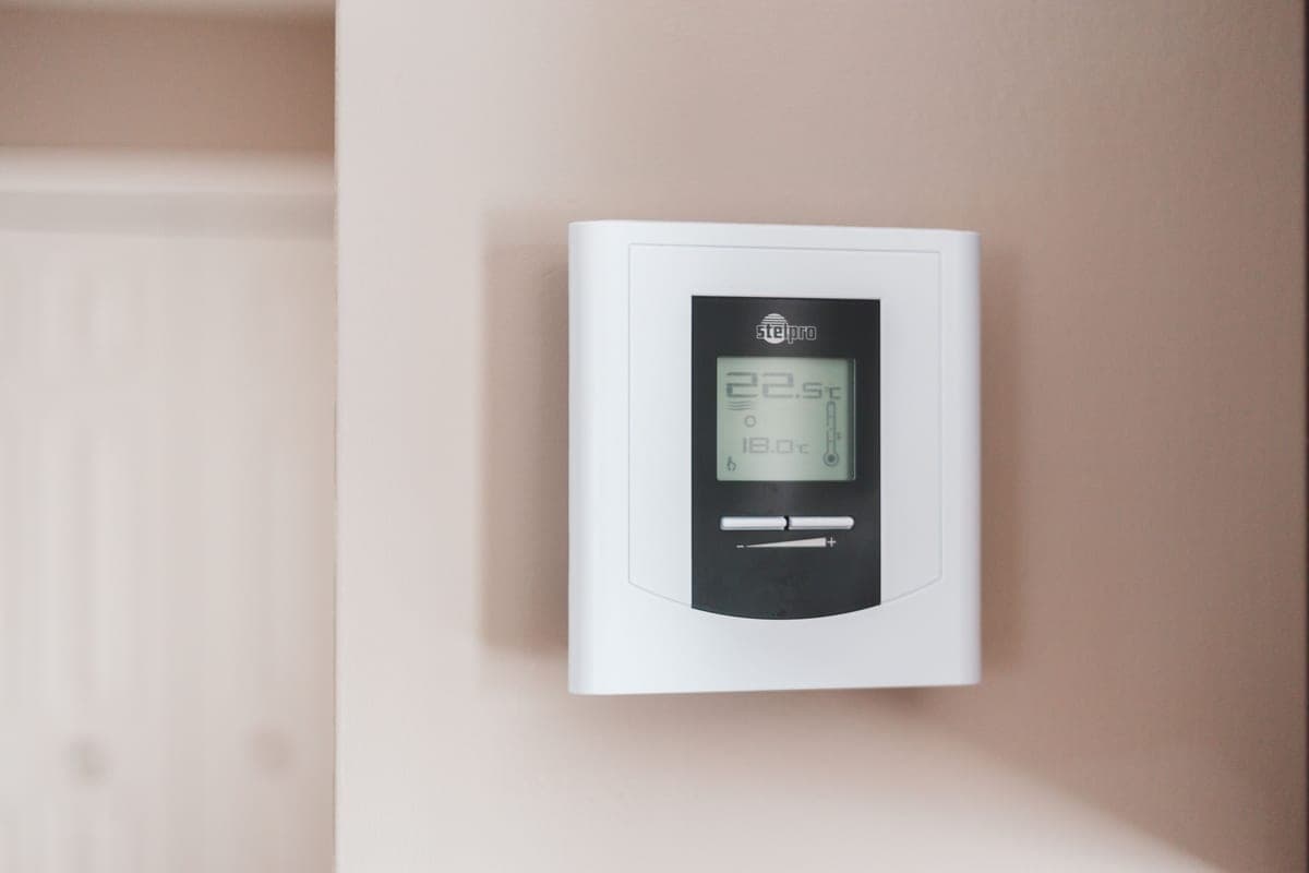 A wall-mounted home thermostat dial