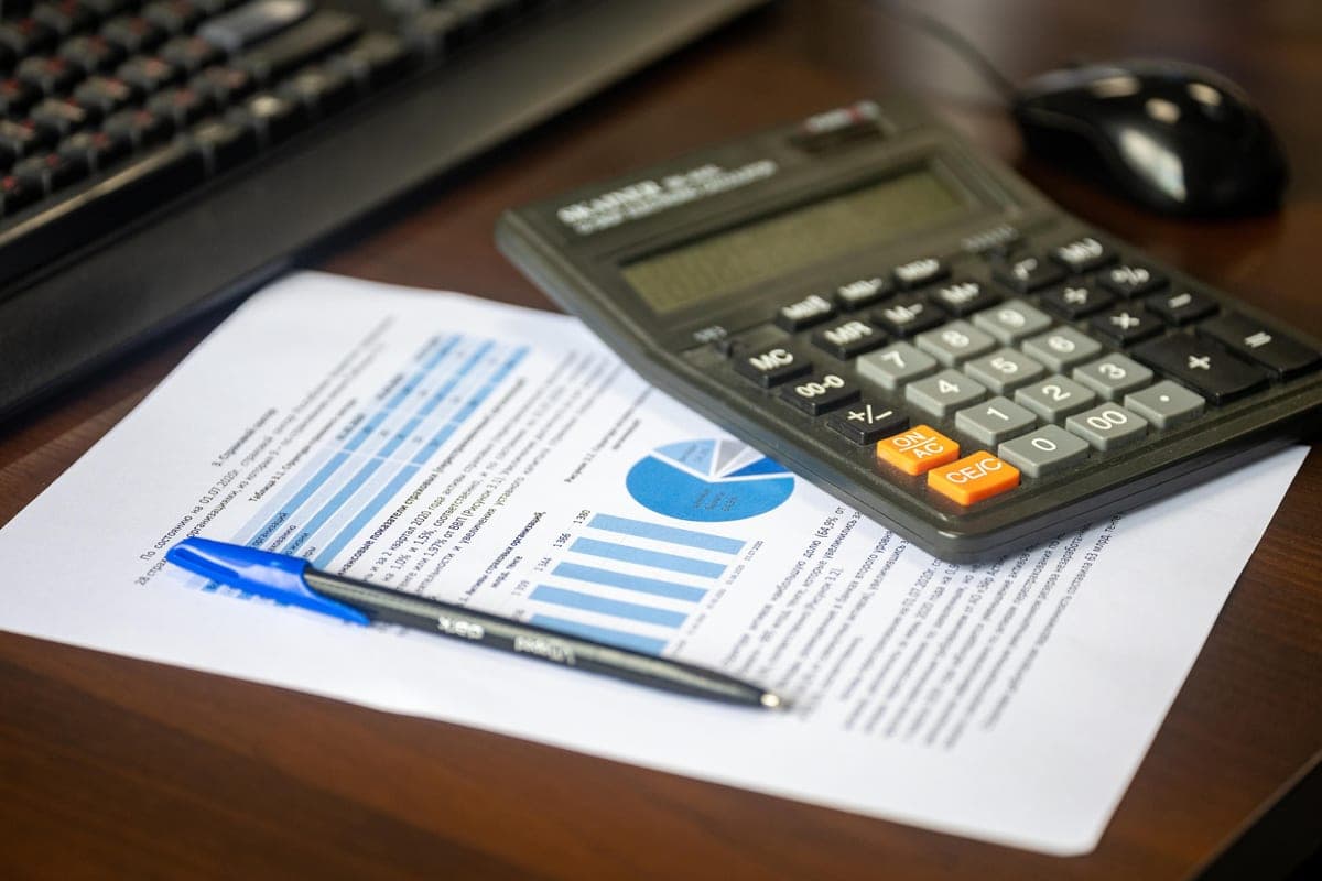 A calculator and paperwork on a desk