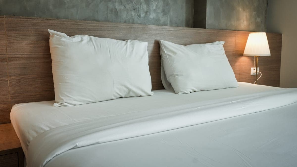 A large bed made up with white hotel linens