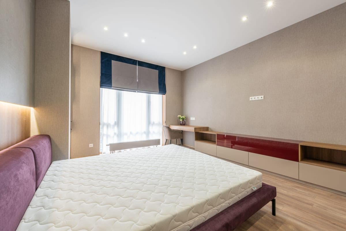 A foam mattress topper layered on a bed