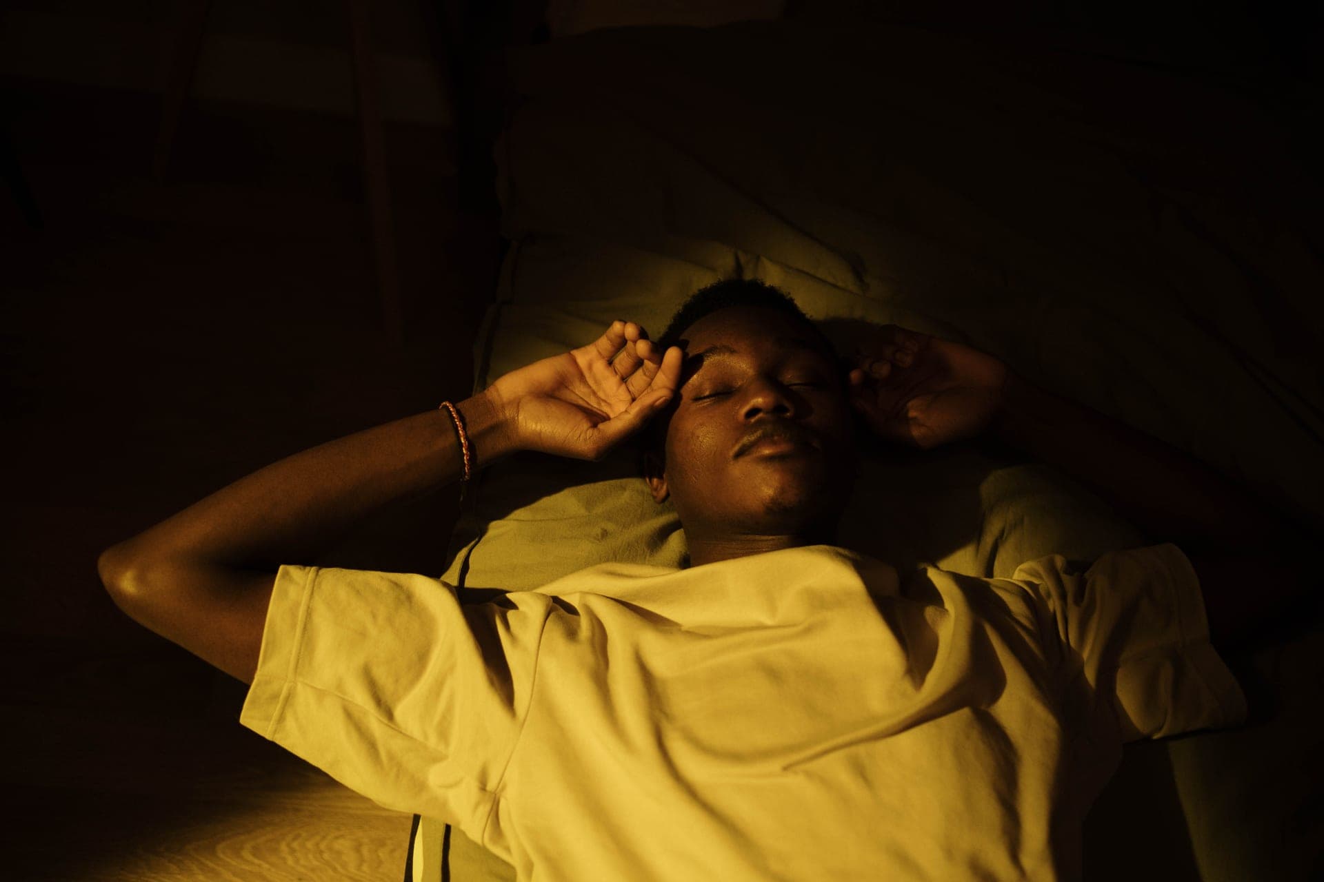 A person asleep in a warmly lit room