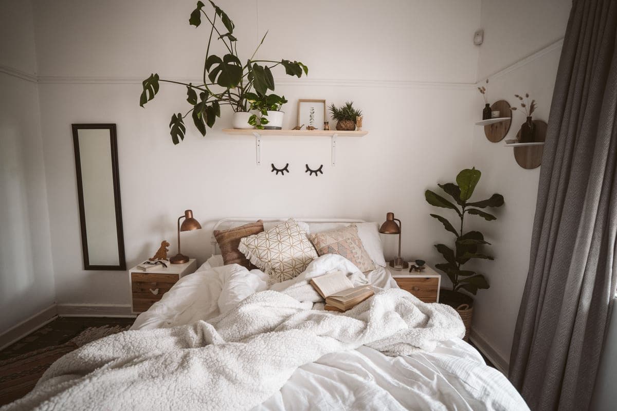 A throw blanket folded at the corner of a bed