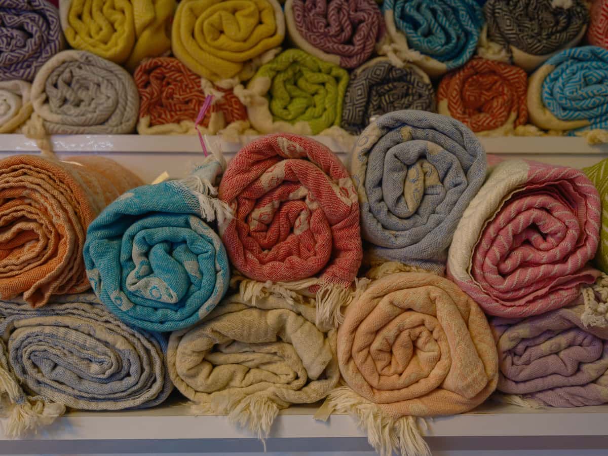 A stack of folded blankets on a shelf
